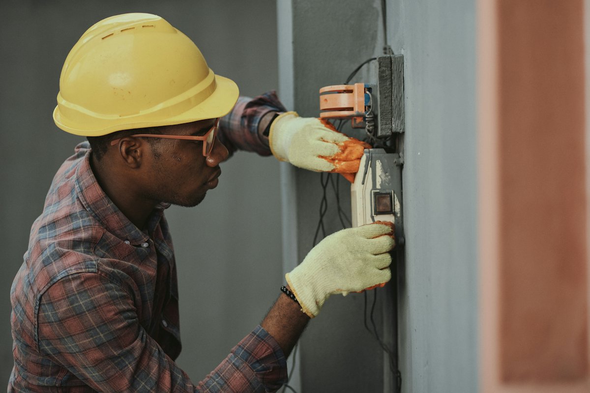 An electrician testing a power panel